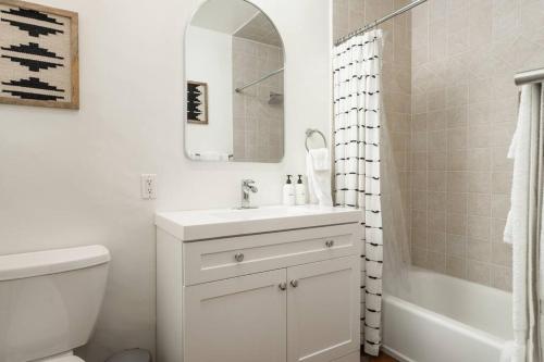 a bathroom with a sink and a toilet and a mirror at 1 Bedroom Casita - Casa Blanca in Montecito