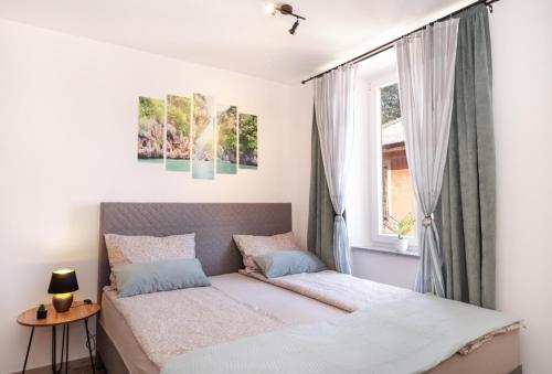 a bedroom with a bed and a window at Apartma Mimi in Izola