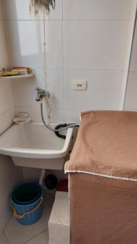 a small bathroom with a sink and a bed at Praia Grande, Canto do Forte, Apto ,2 noites seguidas , apenas 2 diárias com Wi-Fi in Praia Grande