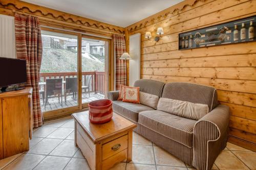 a living room with a couch and a television at Appartments in Tignes Ecrin des Neiges in Tignes