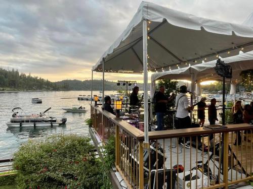 a group of people standing on a dock near a lake at The Pines Resort & Conference Center in Bass Lake