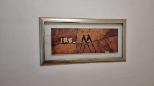 a framed picture of a painting on a wall at Premier Triple room MZ in Vienna