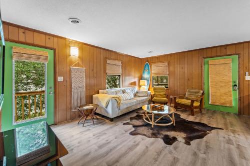 a living room with a bed and a table at Sunny Daze KDH by Village Reality in Kill Devil Hills