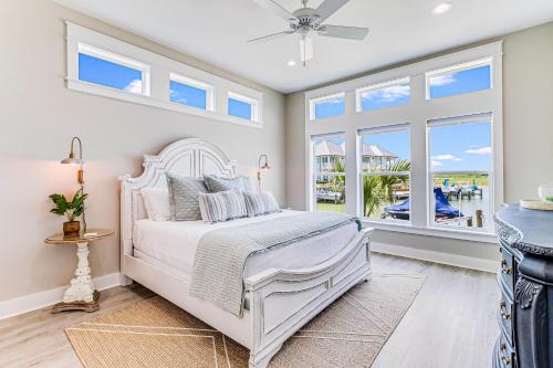 a white bedroom with a bed and a window at Waterfront Wonderland in Rockport