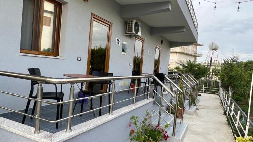 a balcony of a house with a table and chairs at Serene Stay in Vlorë