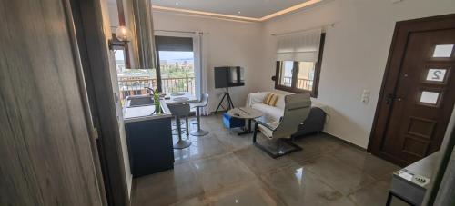 a living room with a couch and a chair in a room at Theasis 2 in Neos Marmaras