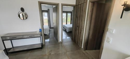 a room with a bed and a table and a mirror at Theasis 2 in Neos Marmaras