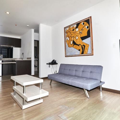 a living room with a couch and a table at Hotel & Suites en Cuenca, Venue Batán in Cuenca