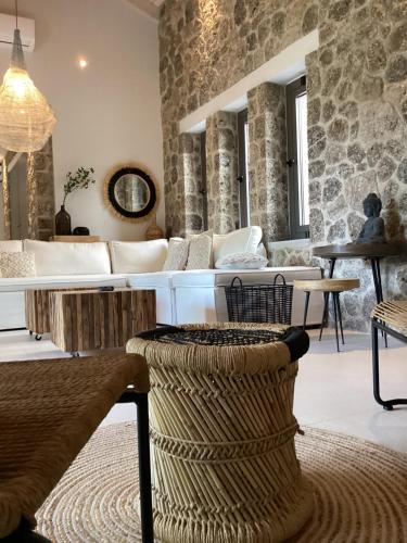 a living room with a couch and a table at Villa Tartaya in Dassia