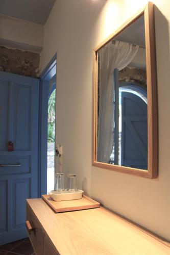 a bathroom with a mirror and a wooden counter at Arenaria Leucadia in Agios Nikitas