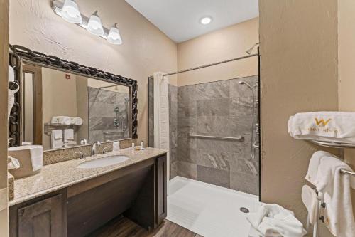 a bathroom with a sink and a shower at Wagon Wheel Hotel in West Yellowstone