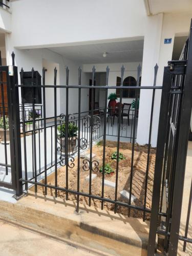 a iron fence in front of a building at Cozy apartment in Nea Kios in Néa Kíos