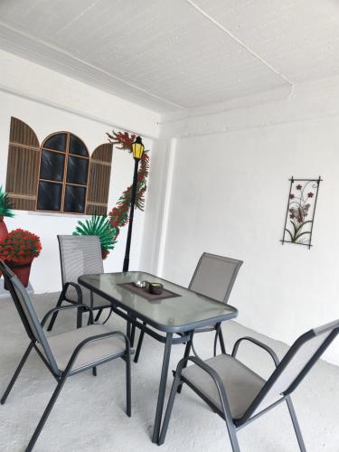 a dining room with a table and chairs at Cozy apartment in Nea Kios in Néa Kíos