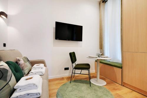 - un salon avec un canapé, une chaise et une table dans l'établissement Attractive studio - 2P - Auteuil - Parc des Prince, à Paris