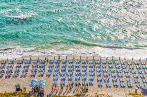 an overhead view of a beach with chairs and umbrellas at Splendid Resort - Oceanview 1BDR & 1BA Apt Right on the Beach, Heated pool, GYM in Hollywood