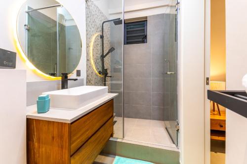 a bathroom with a sink and a shower at Charming 2-Bed Apartment in Grand Baie in Grand Baie