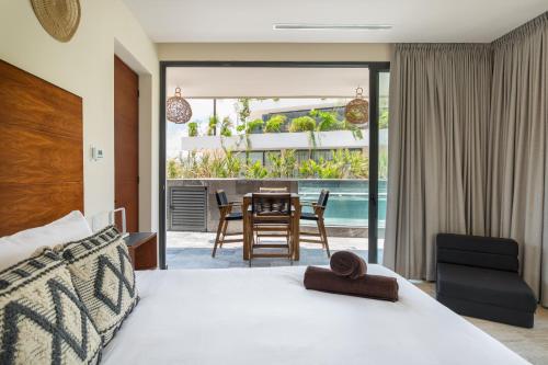 une chambre avec un lit, une table et des chaises dans l'établissement Mistiq Temple I, à Tulum