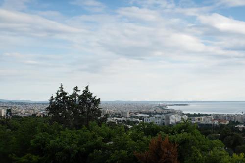 uma vista para uma cidade a partir de uma colina com árvores em Old town view apartment em Tessalônica