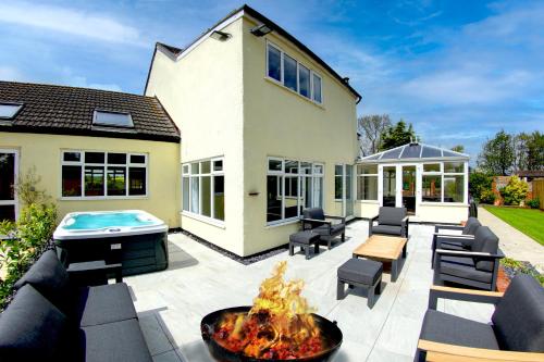 a patio with a fire pit in front of a house at The Willows in Laceby