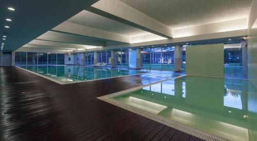 a large swimming pool in a building at Aqualuz Troia Mar by The Editory in Troia