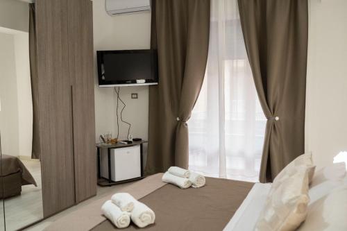a bedroom with a bed with towels on it at B&BSCICCHERI in Castellammare di Stabia