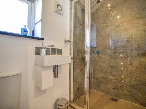 a bathroom with a sink and a shower at The Old Garage in Lyme Regis