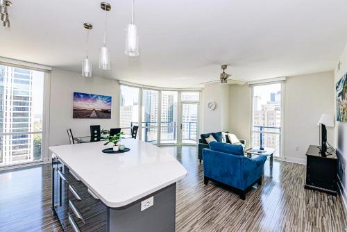 an open living room with a couch and a table at Corporate Uptown Furnished Apartments in Charlotte