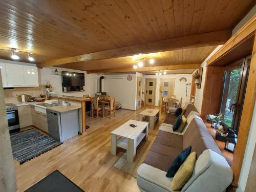 ein Wohnzimmer und eine Küche mit einem Sofa und einem Tisch in der Unterkunft Chata u Michala- neakceptujeme mladé partie in Terchová