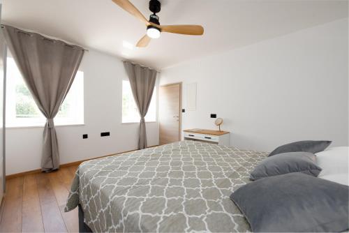 a bedroom with a bed and a ceiling fan at Casa Fiumana Laura in Rijeka