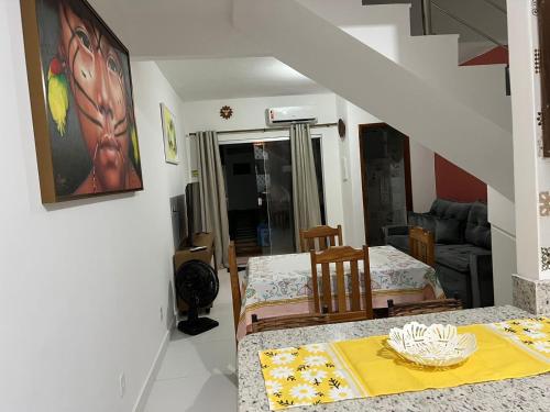 een woonkamer met een tafel en een eetkamer bij Lindo Apê em Coroa Vermelha BA in Santa Cruz Cabrália