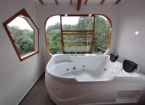 a large white bath tub in a bathroom with a window at ASGARD Spa in San Agustín