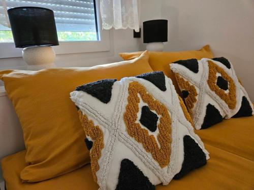 a bed with pillows on top of it at Svalinn in Belišće