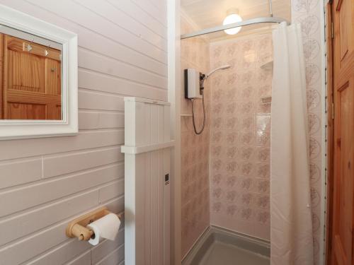a bathroom with a shower with a glass door at Little Gem in Maryport