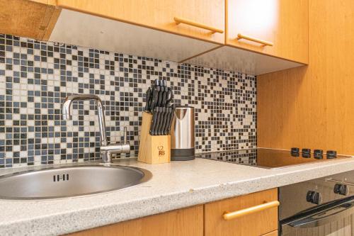 a kitchen counter with a sink and a knife block at Stunning Apartment - Ideal for 3 people in Vienna