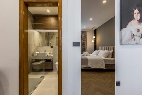 - une chambre et une salle de bains avec un lit et un miroir dans l'établissement Luxury rooms Bolero, à Split