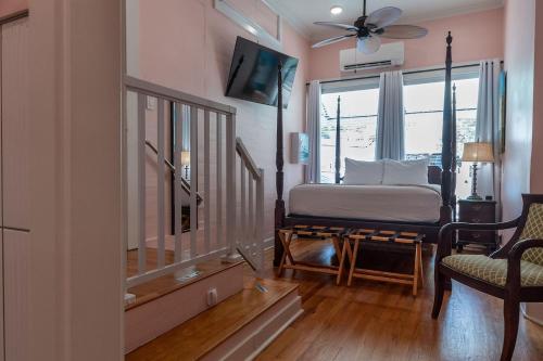 a bedroom with a bed and a large window at The Porch on Frances Inn - Adults Exclusive in Key West