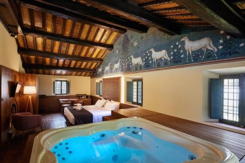 a hotel room with a jacuzzi tub in a room at La Loggia Historic Resort in Gradara