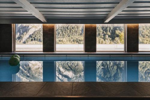 a swimming pool with a view of the mountains at Familienhotel Lagant in Brand