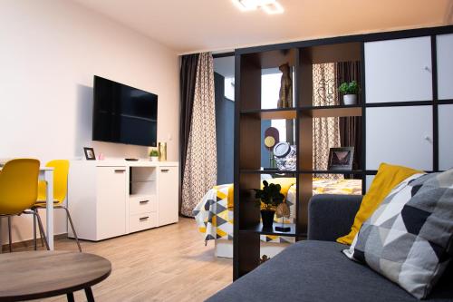 a living room with a couch and a tv at Apartment Figurin in Dubrovnik