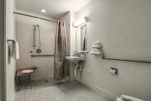 a bathroom with a sink and a shower at Motel 6-Fontana, CA in Fontana