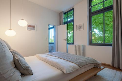 a bedroom with a bed and two windows at Ferienwohnung mit malerischem Ausblick in Billerbeck