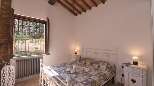 una camera con letto e finestra di Casina di Teo a Monteriggioni
