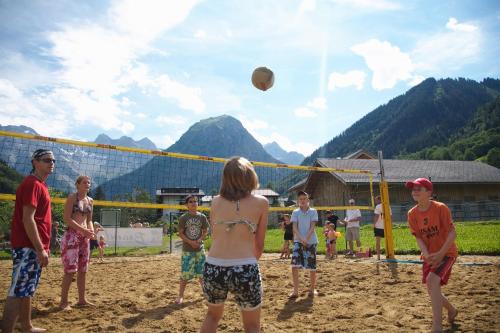 a group of people playing volleyball on a beach at Familienhotel Lagant in Brand