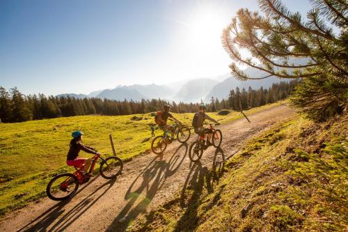 a group of people riding bikes down a dirt road at Familienhotel Lagant in Brand