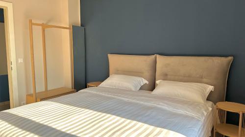 a bedroom with a large bed with two pillows at Homely Stay Apartment 3 in Sankt Pölten