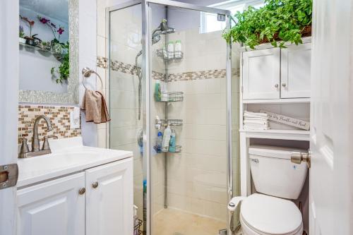 a bathroom with a shower and a toilet and a sink at Lush Vallejo Cottage - 20 Mi to Napa Wineries in Vallejo