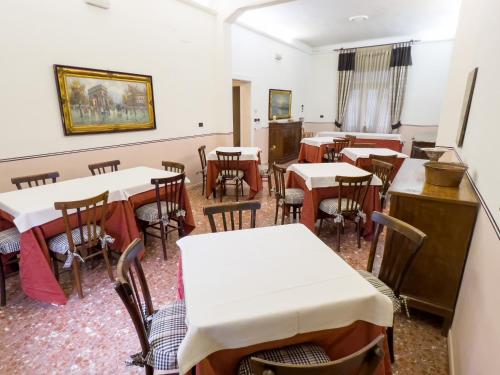 an empty dining room with tables and chairs at Monte Marsicano Hotel in Pescasseroli