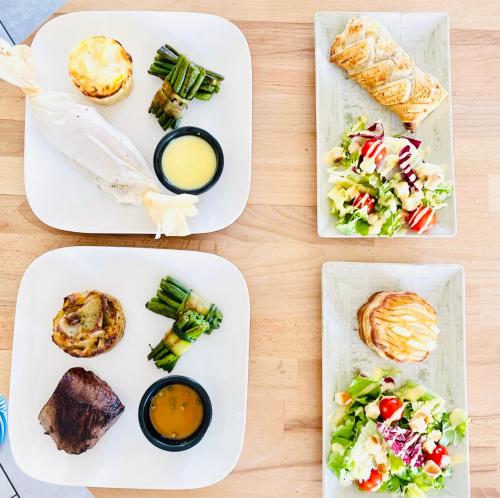 four white plates with different types of food on them at La Bulle de Romance - Love Room in Tigy