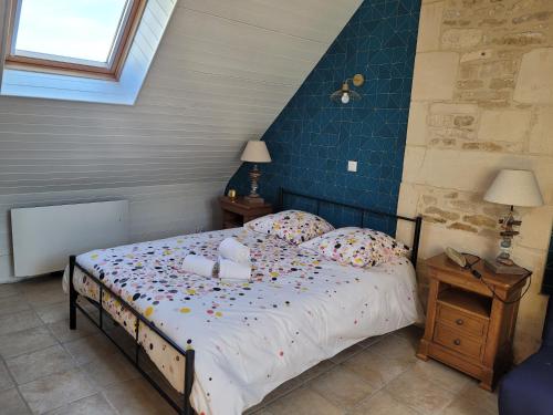 a bedroom with a bed with sprinkles on it at Maison de pêcheur charmante et atypique en pierre, 1 min de marche de la mer in Saint-Aubin-sur-Mer