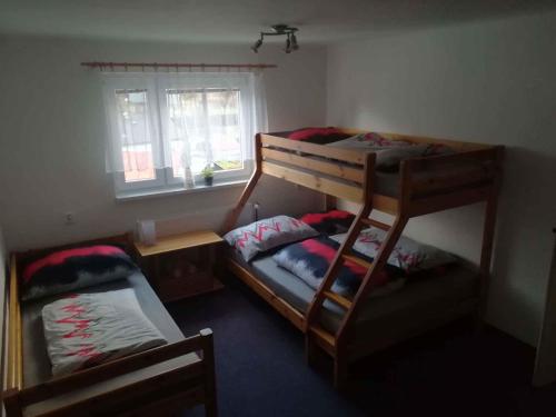two bunk beds in a room with a window at Holiday home in Rokytnice n. J. 35171 in Rokytnice nad Jizerou
